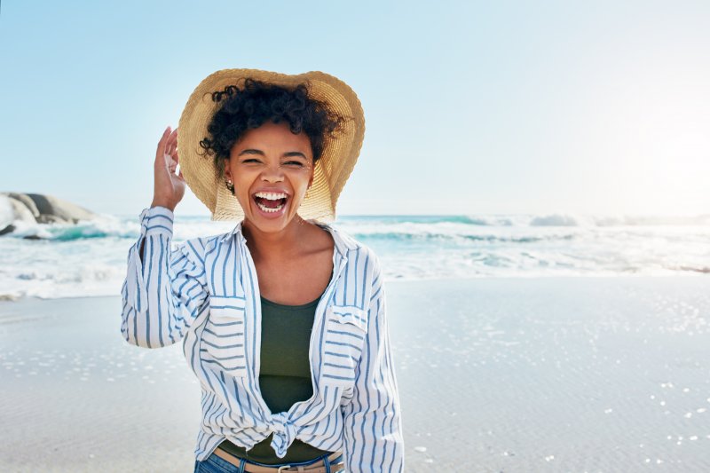 Woman smiling while at the beach